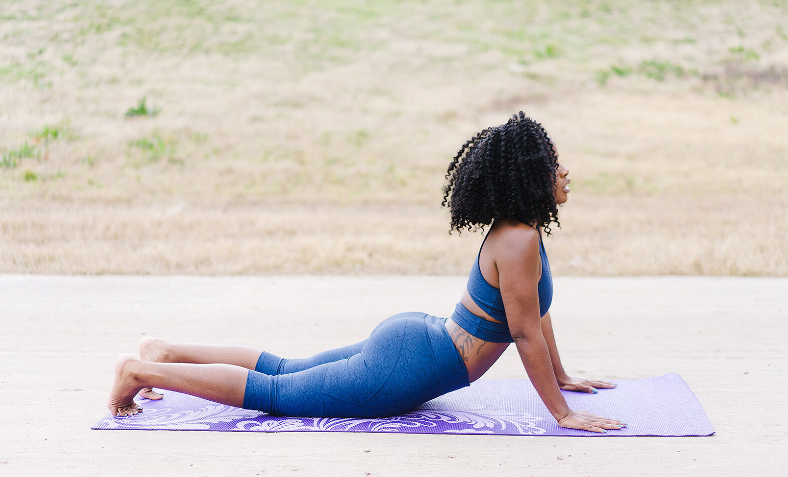 A black woman doing yoga
