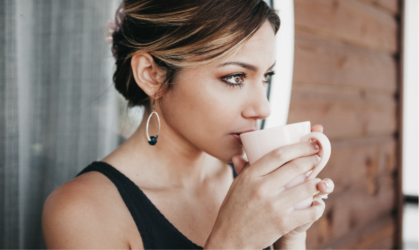 A woman sipping from her cup