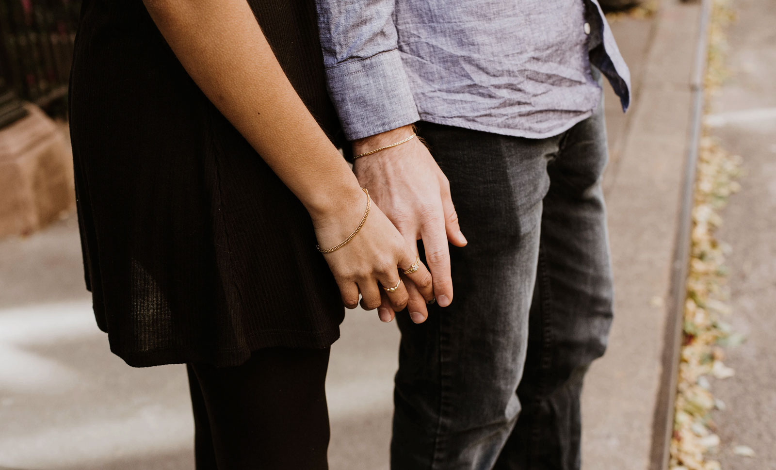 A woman about to hold the hand of a man