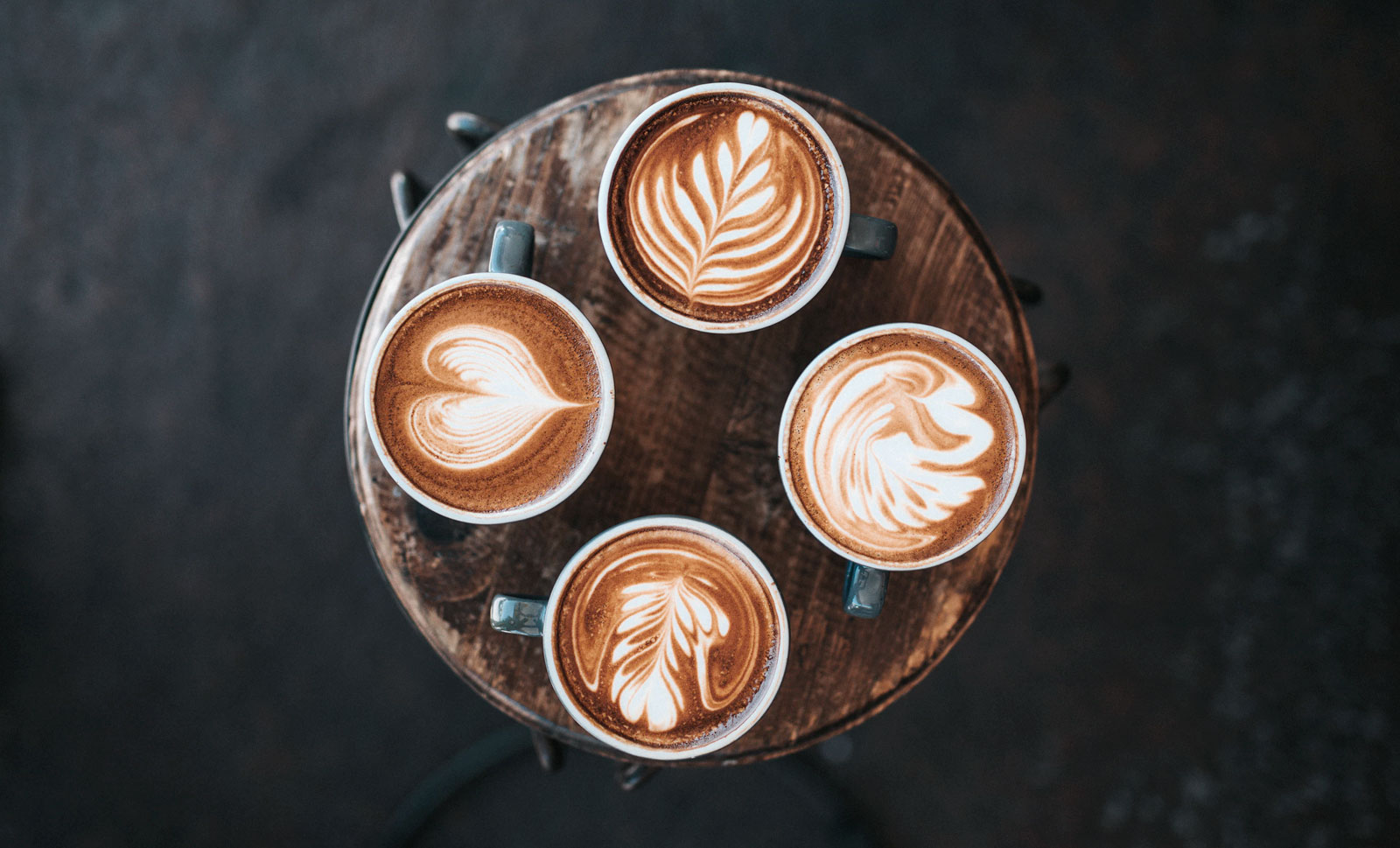 Four cups of coffee with latte art