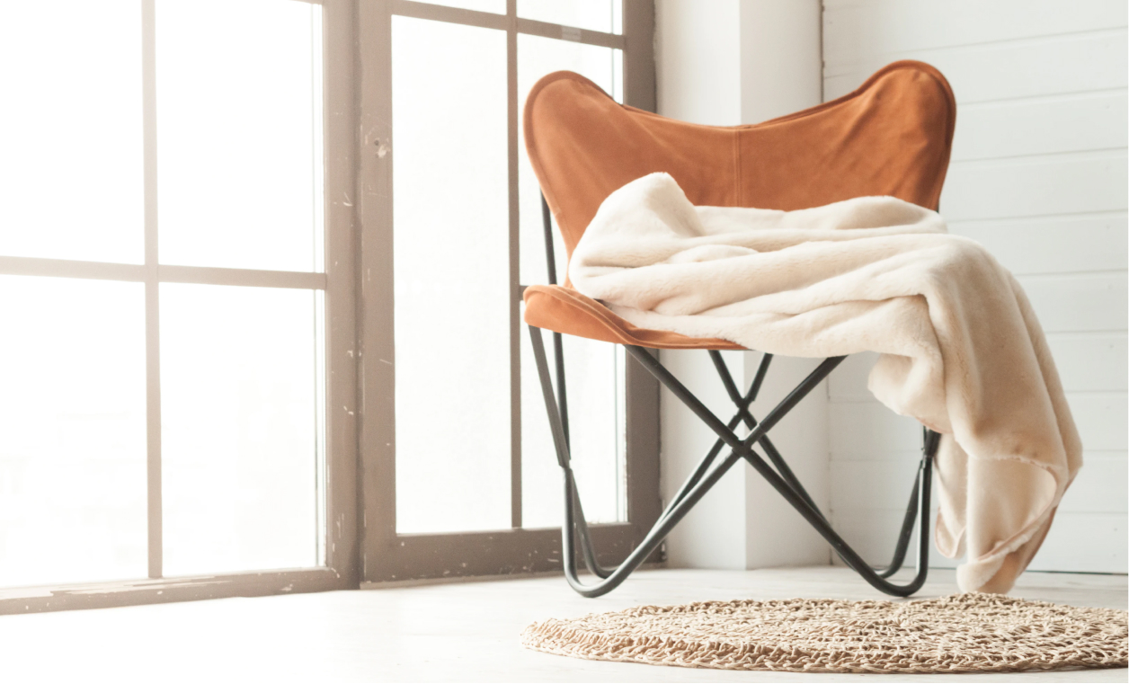 A brown chair with a blanket