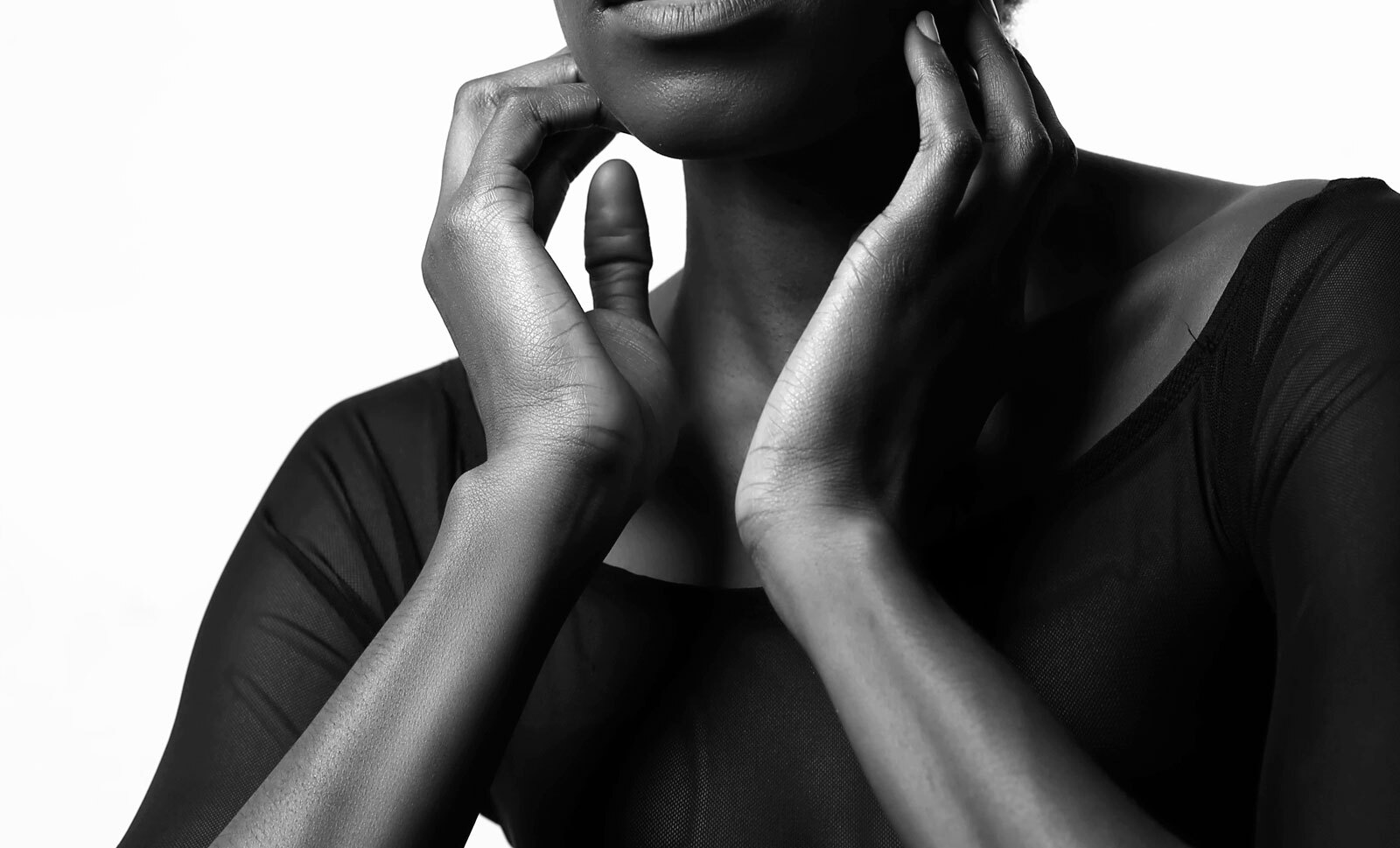 A black woman touching her face